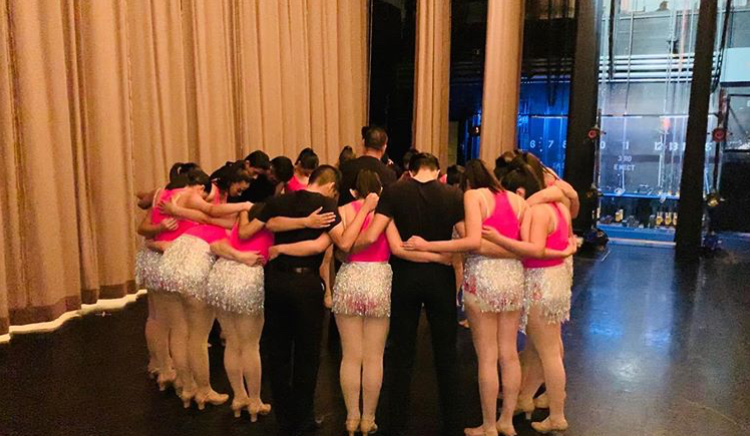 Dancers pray before performance. 