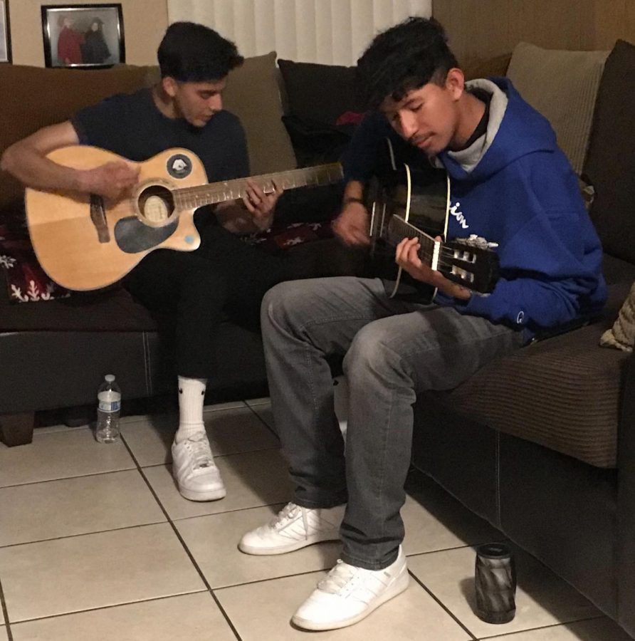 Roberto and Matthew Prado playing guitar. 