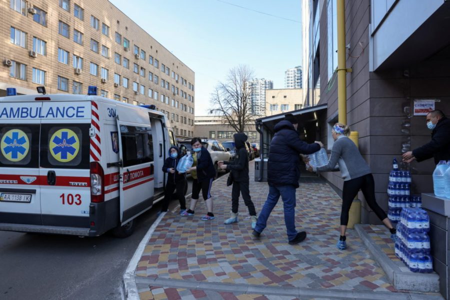 Staff of Okhmadet Childrens Hospital carry water to the hospital from an ambulance, as Russias invasion of Ukraine continues, in Kyiv, Ukraine February 28, 2022. REUTERS/Umit Bektas