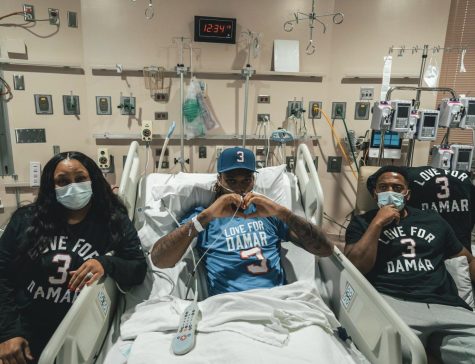 Damar Hamlin showing a heart to his fans while recovering at the hospital.